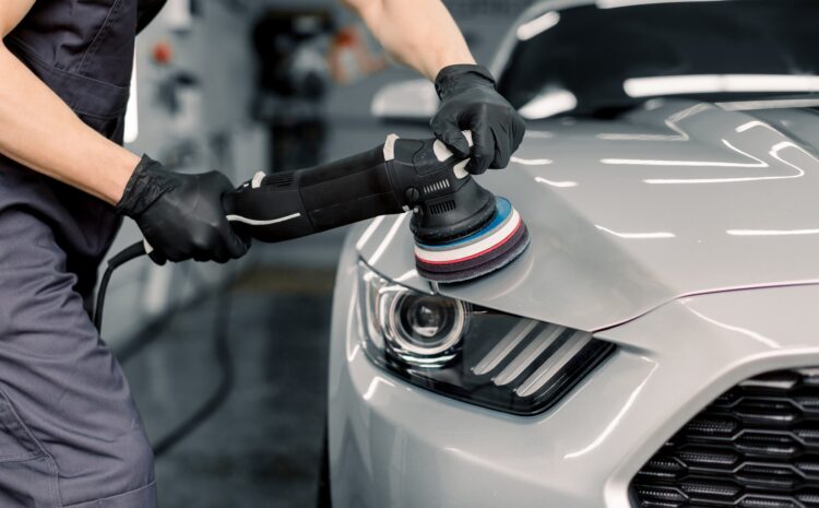 Car detailing and polishing concept. Hands of professional car service male worker, with orbital Car detailing and polishing concept. Hands of professional car service male worker, with orbital